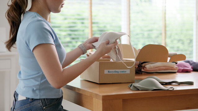 Asia woman people dispose bin dump old undies pack donate box manage send used bra bank throw away. Happy asian eco go green home reduce net zero waste reuse cotton fabric fast fashion social issue.