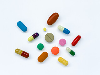 Colorful Capsules and Tablets on White Background