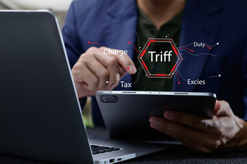 Businessman Analyzing Tax Principles on Tablet with Laptop Nearby