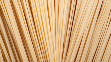 Close-up image of uncooked spaghetti pasta strands arranged vertically, showcasing their texture and light beige color.