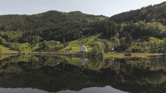 Granvin Church In The Shore Of The Granvinsvatnet In Vestland, Norway. - aerial shot