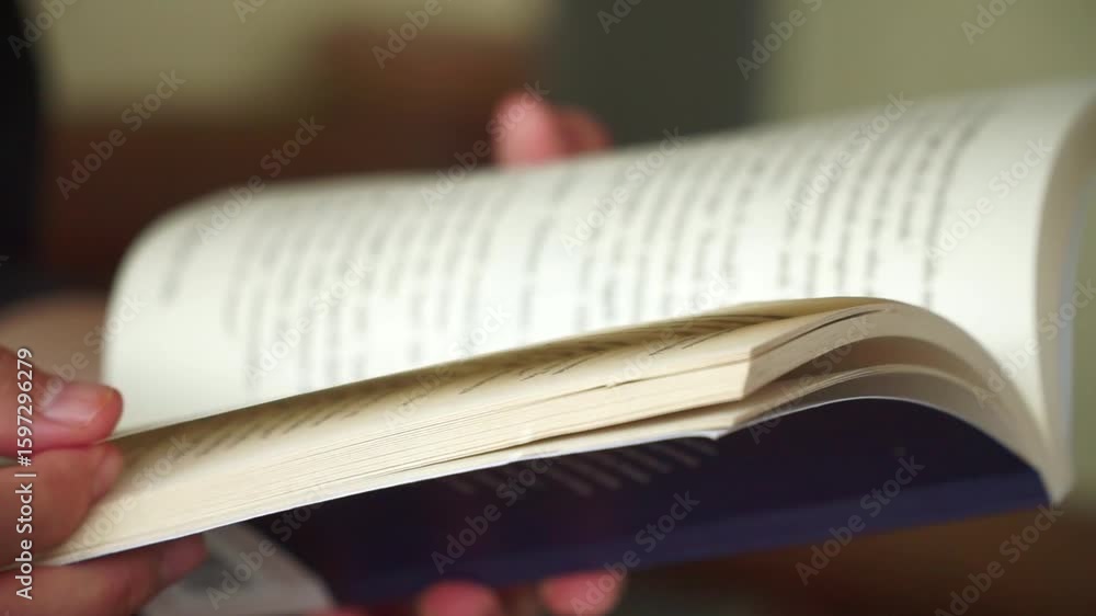 Poster close-up view of hands gently flipping through a book, capturing a calm and mindful reading session.