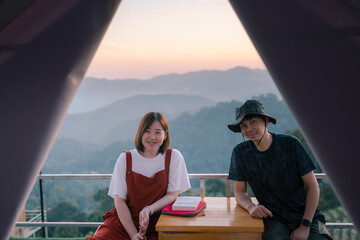 asian couple relax with travel in honeymoon trip with mountain background