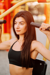 Young woman exercising outdoors in a fitness park during golden hour