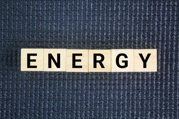 Wooden cube with the word energy. the strength and vitality required for sustained physical or...