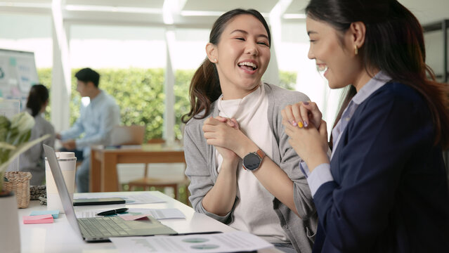 Young adult asian people asia woman high five smile work at office receive idea good news email happy joy bonus pay win sale award, order test job exam result, loan money banking approve e-mail winner
