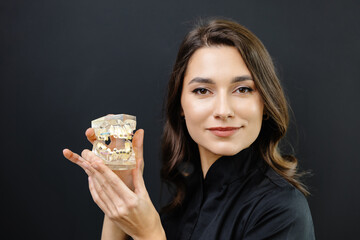 Orthopedic dentist doctor is holding teeth 3d printed model of the patient's jaw with malocclusion
