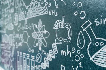 Science chalkboard with hand-drawn chemistry formulas, physics equations, DNA, and educational...