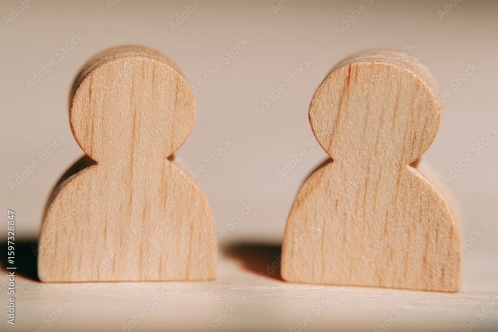 Poster two wooden figures representing pairs mirroring emotions of connection and collaboration in a neutra