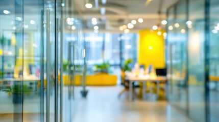 Brightly lit modern office space with glass partitions and vibrant yellow accents. Employees are engaged in work amidst a clean and organized environment during daytime.