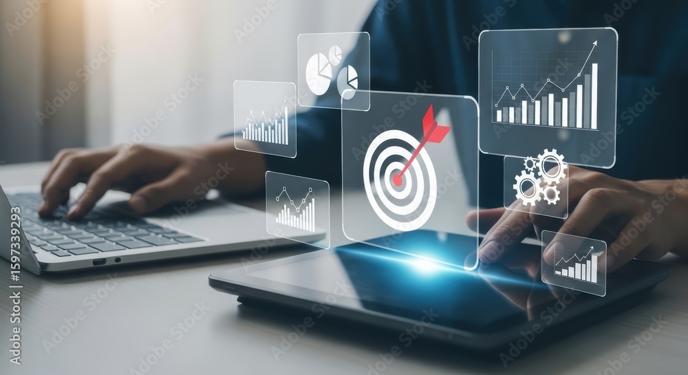 Fototapete a person's hands interact with a tablet displaying digital graphics of charts data and a target with
