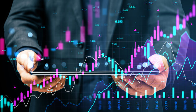 Businessman holding tablet and smartphone showing financial market data with holographic forex charts, candlesticks, and index reports overlayed.