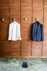 Wedding attire preparation in elegant venue with wooden backdrop