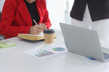 Teamwork of business people brainstorming with financial data graph analysis on the table in the...