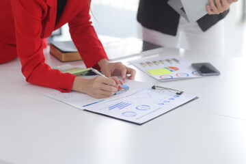 Teamwork of business people brainstorming with financial data graph analysis on the table in the...