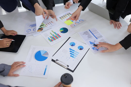 Teamwork of business people brainstorming with financial data graph analysis on the table in the meeting room. - Powered by Adobe