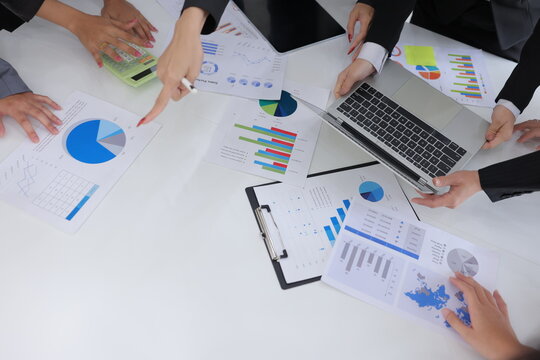 Teamwork of business people brainstorming with financial data graph analysis on the table in the meeting room.