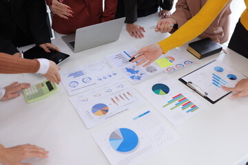 Teamwork of business people brainstorming with financial data graph analysis on the table in the...