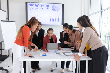 Teamwork of business people brainstorming with financial data graph analysis on the table in the...
