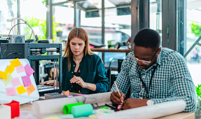 Obraz premium Diverse Startup Team Working on 3D Printing Project