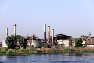 Abandoned industrial zone on the banks of the Nile River, Egypt. Old derelict factory with...