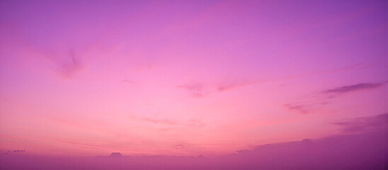 Dramatic cloudy sky at sunset with beautiful pink, purple and orange colors, a vibrant abstract nature background or texture overlay