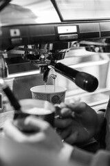 Espresso Being Prepared in a Cafe With a Barista Using a Machine to Extract Coffee in the Morning Light