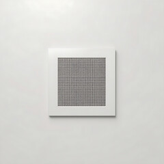 A white square ventilation grille is placed on a white wall.