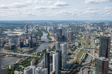 Fototapeta premium Overview of Modern Urban Landscape in Moscow Featuring High-Rise Buildings and the River on a Clear Day
