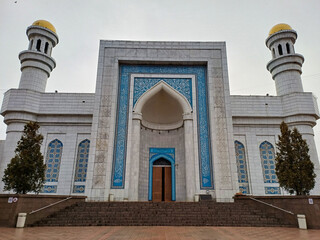 Almaty, Kazakhstan - 22 March 2024: The grand facade of the Central Mosque, features light gray...