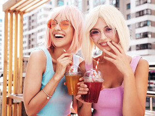 Two young beautiful smiling hipster female in trendy summer clothes. Sexy carefree women posing in...