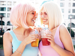 Two young beautiful smiling hipster female in trendy summer clothes. Sexy carefree women posing in...
