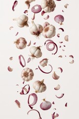 Fresh garlic heads and sliced red onions isolated in dynamic floating layout for herb and vegetable themes.

