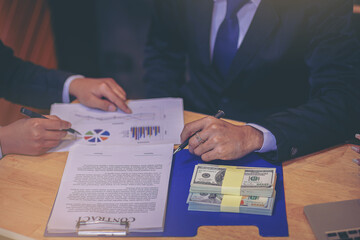 Business Negotiation concept: Businessman presents marketing plan to attract business partner to invest in project. Selected focus