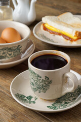 Traditional Black Coffee in Classic Kopitiam Cup on Table for Vintage Malaysian Breakfast Concept