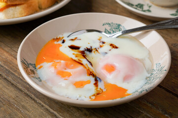 Traditional Kopitiam: Two Half-Boiled Eggs Served on a Small Plate for Malaysian Breakfast and Local Food Culture