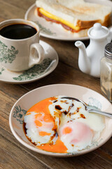 Traditional Kopitiam: Two Half-Boiled Eggs Served on a Small Plate for Malaysian Breakfast and Local Food Culture