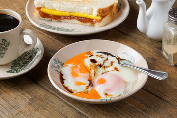 Traditional Kopitiam: Two Half-Boiled Eggs Served on a Small Plate for Malaysian Breakfast and...