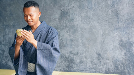 A black man wearing a yukata and experiencing a tea ceremony