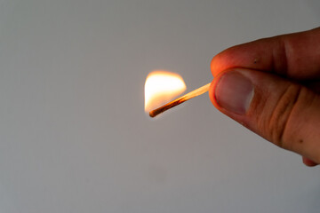 burning match in hand