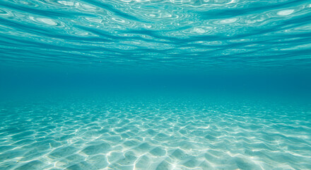 Serene underwater view of crystal clear turquoise ocean water and sandy seabed