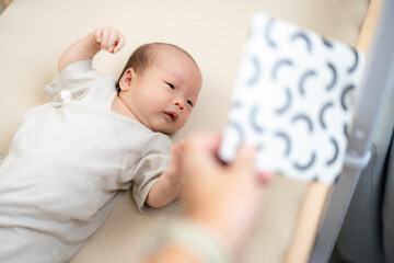 Black and white card placed near newborn baby son
