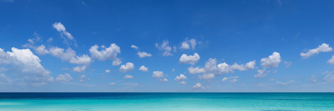 Panoramic view of tropical ocean and cloudscape on sunny day