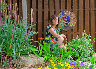 Beautiful lady, reflecting in a Japanese style garden, in July, 2025.