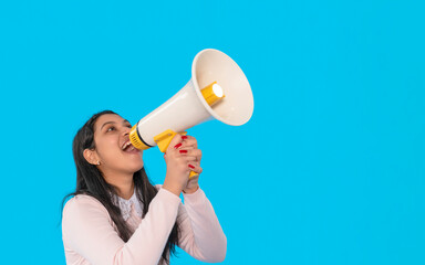 Woman enthusiastically speaks into a megaphone against a vibrant blue background