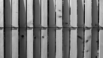 Vertical wooden slat fence in black and white