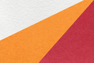 Texture of old craft white, orange and red color paper background, macro. Vintage abstract wine cardboard