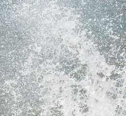 A large splash of water, with white foam and bubbles