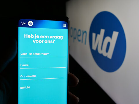 Stuttgart, Germany - 07-11-2025: Person holding cellphone with webpage of Open Vlaamse Liberalen en Democraten Open VLD on screen in front of logo. Focus on center of phone display.