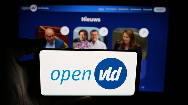 Stuttgart, Germany - 07-11-2025: Person holding cellphone with logo of Open Vlaamse Liberalen en Democraten Open VLD on screen in front of webpage. Focus on phone display.